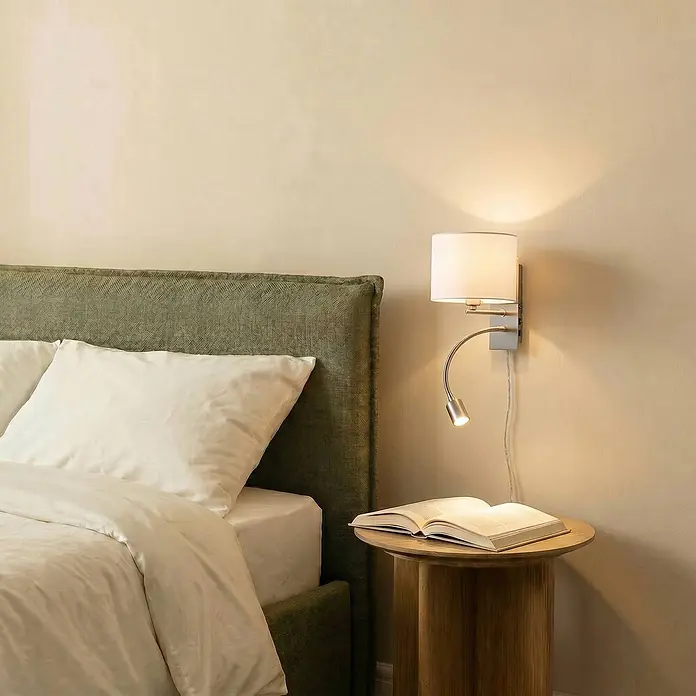 Lindby Wandleuchte Florens - L x B x H: 24 x 18 x 23,5 cm, alu / grau / zink, E14 - Wandmontierte Nachttischlampe mit weißem Schirm & flexibler Leselampe, beleuchtet ein Buch auf einem Holznachttisch.