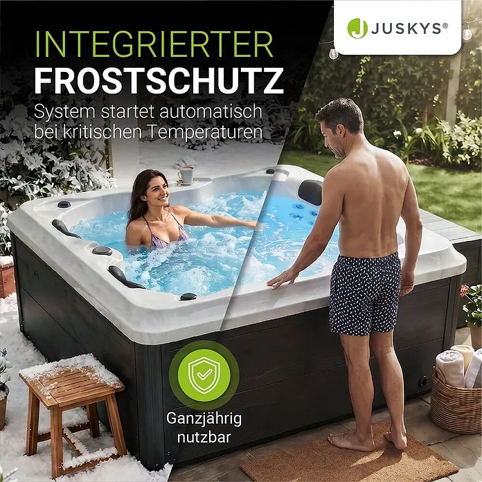 Artsauna Außen-Whirlpool Oasis - 160 x 210 x 80 cm, Grau - Dunkelgrauer und weißer Whirlpool mit integriertem Frostschutz, von Paar in verschneitem Garten genutzt, ganzjährig nutzbar.