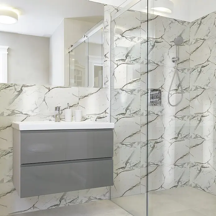 Panel de pared Mármol - 60 x 30 cm, Blanco, 2 ud. - Baño moderno con mueble de lavabo flotante gris, lavabo blanco, azulejos efecto mármol y ducha de cristal.