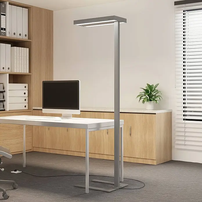 Arcchio Stehleuchte Logan Ultra - alu / grau / zink, alu / grau / zink - Hohe graue Metall-Stehleuchte beleuchtet modernen Bürobereich mit Schreibtisch und Computer.