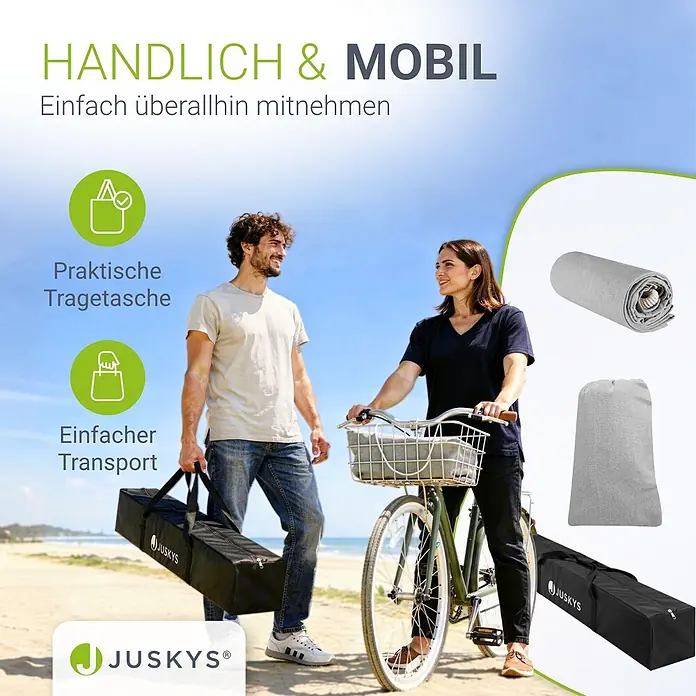 Juskys Hängematten-Set Paya - L x B x H: 279 x 109 x 101 cm, Hellgrau - Graue tragbare Matte mit schwarzer Tragetasche, von Personen einfach am Strand transportiert.
