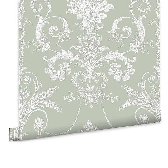 Laura Ashley Vliestapete Josette Damast - Grün, Ornament, 1.000 x 52 cm - Teilweise ausgerollte hellgrüne Tapete mit einem verzierten weißen Blumen- und Damastmuster.