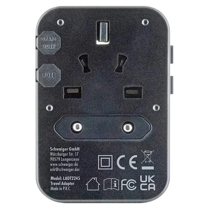 Schwaiger Reiseadapter All-in-One Weltreiseadapter - Schwarz - Dunkelgrauer internationaler Reiseadapter mit verschiedenen Steckdosen, Sicherungsfächern und Beschriftungen.