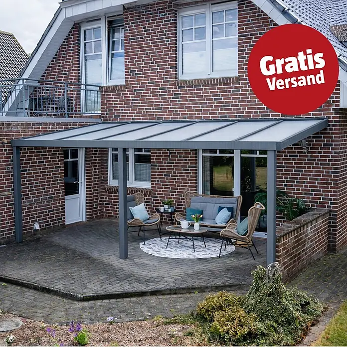 Gardendreams Terrassenüberdachung Elegance - B x T: 500 x 405,5 cm, Graualuminium, Polycarbonat, Opal - Dunkelgraue Terrassenüberdachung mit transluzidem Dach, über einem Sitzbereich am Backsteinhaus installiert.