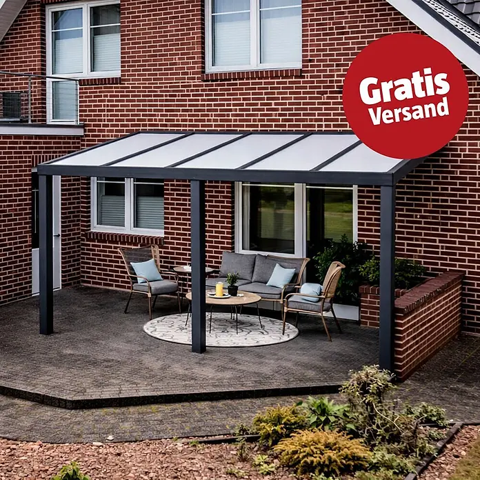 Gardendreams Terrassenüberdachung Elegance - B x T: 600 x 305,5 cm, Anthrazitgrau, Polycarbonat, Opal - Dunkelgraue Terrassenüberdachung mit transluzentem Dach, bietet Schutz für Gartenmöbel an einem Backsteinhaus.