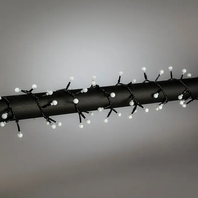 Konstsmide LED-Clusterlichterkette Globe Pastell - Außen, Länge: 8,78 cm, Netzbetrieben - Weiße kugelförmige LED-Lichterkette mit schwarzen Kabeln um ein schwarzes Rohr gewickelt.