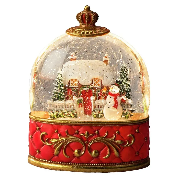 Konstsmide LED-Schneelaterne Schneemann mit Haus - Innen, Rot, 15,5 x 9 x 20 cm, Batteriebetrieben - Weihnachtsschneekugel mit rotem Steppsockel, goldenen Akzenten und klarer Kuppel, die eine Winterhausszene zeigt.