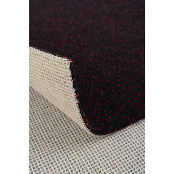 Bricoflor Teppichboden Meterware 9x4m, Velours gemustert, schwarz rot - Velours, 100 % Polyamid (PA), schwarz rot - Schwarzer Teppich mit roten Sprenkeln, umgeklappt, um die beigefarbene Gitterunterseite zu zeigen.