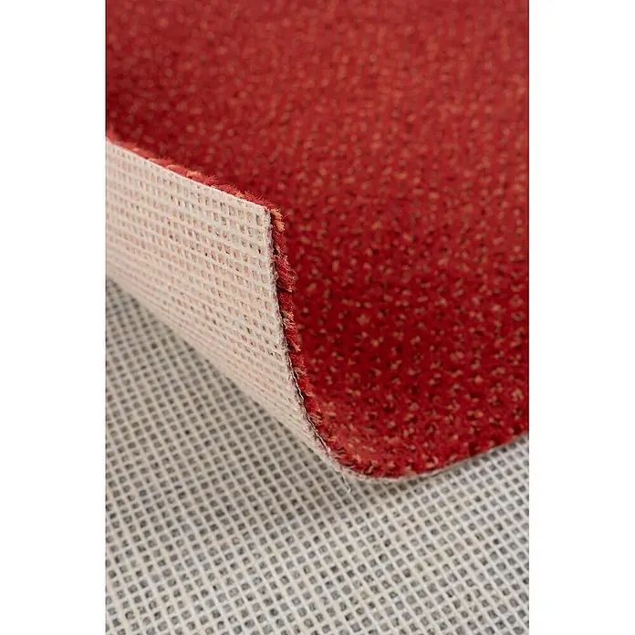 Bricoflor Teppichboden Meterware 5,5x4m, Velours gemustert, rot - Velours, 100 % Polyamid (PA), rot - Roter strukturierter Teppich, hochgeklappt, um seine weiße rutschfeste Gitterunterseite zu zeigen.