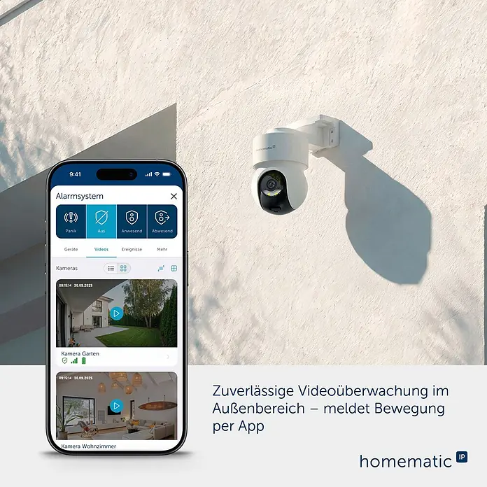 Homematic IP Außenkamera Smart Home HmIP-CO - Weiß - Weiße Homematic Außenkamera an einer Wand; Smartphone zeigt Videofeeds in der App an.