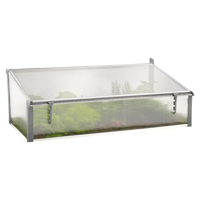 Juwel Vivero Thermo - 125 x 58 x 40 cm, Plástico - Invernadero frío rectangular con paneles corrugados translúcidos y marco plateado, tapa inclinada, plantas visibles.