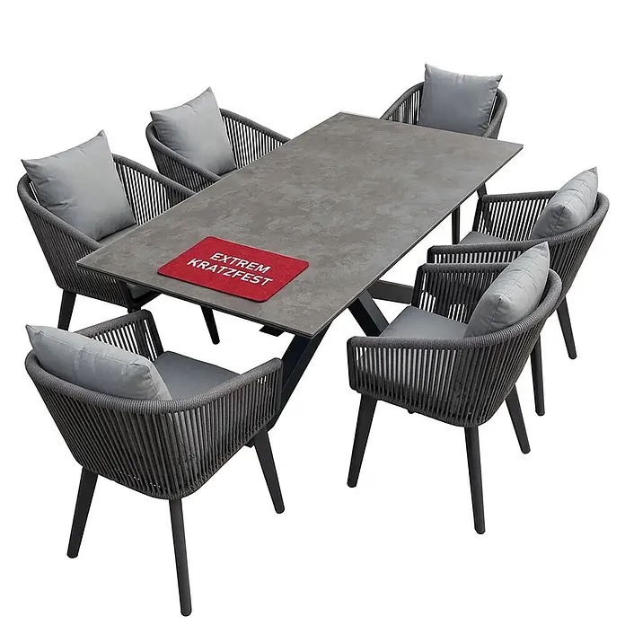 Bene Living Gartentisch-Set Cadiz Almeria - Gesamtumfang: 6 -tlg., Aluminium pulverbeschichtet, Rope-Geflecht, Tischplatte aus gesintertem Stein (Keramik) - Outdoor-Essgruppe mit grauem Tisch und sechs dunkelgrauen Geflechtstühlen mit hellgrauen Kissen.
