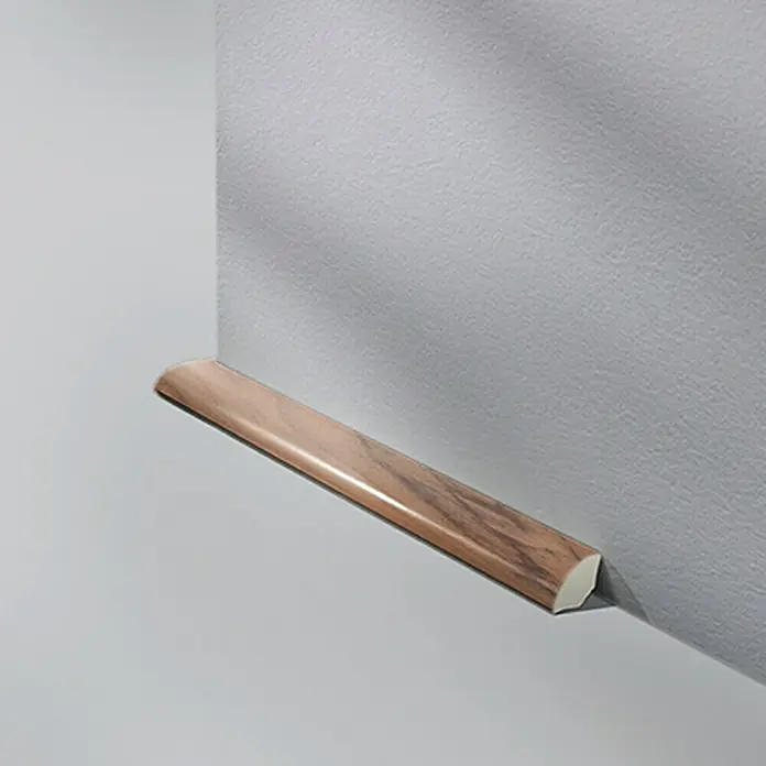 LOGOCLIC Viertelstab Nussbaum - 250 cm x 14 mm x 14 mm - Holzleiste an einer grauen Wand.