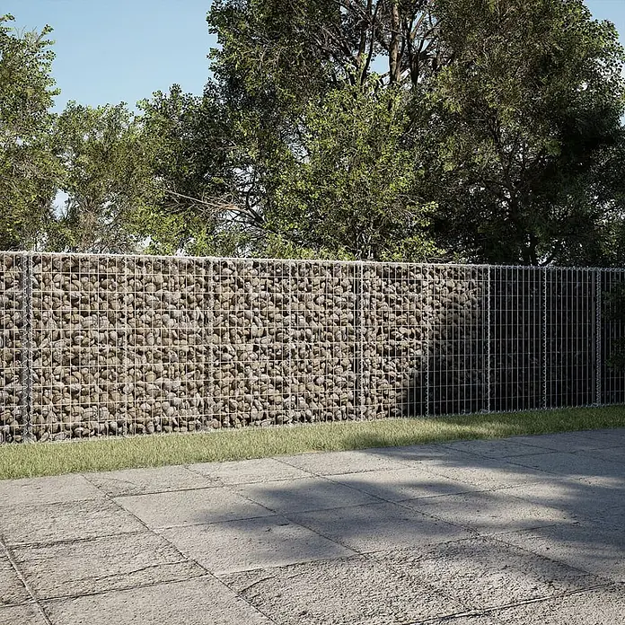Furnicato Gabione - 600 x 50 x 100 cm, Metall, Maschenbreite: 50 mm, Maschenhöhe: 100 mm - Eine Gabionenwand aus Drahtgitter mit Natursteinen im Garten, teils gefüllt, teils nur Drahtgitter.