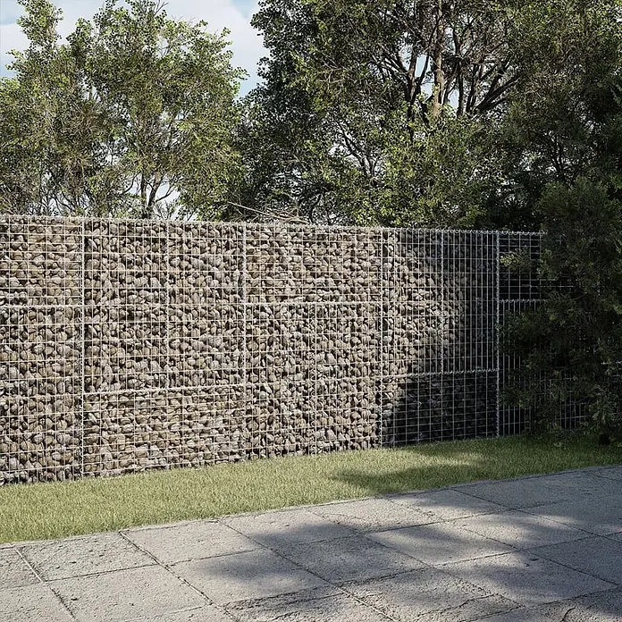 Furnicato Gabione - 300 x 50 x 150 cm, Metall, Maschenbreite: 50 mm, Maschenhöhe: 100 mm - Gabionenzaun, eine robuste Gartengrenze aus Natursteinen in Drahtgitter. Er trennt eine gepflasterte Fläche von einem Garten mit Bäumen.