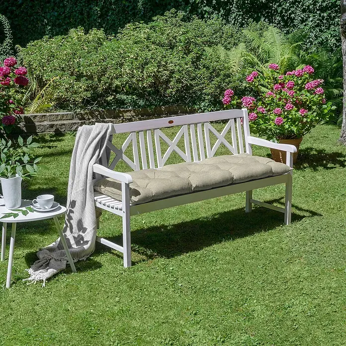 Beautissu Bankauflage Flair BK - Gartenbank, 1 Stk., L x B x H: 100 x 50 x 10 cm, Polyester, Beige - Weiße Gartenbank mit beigem Kissen in einem sonnigen Garten.