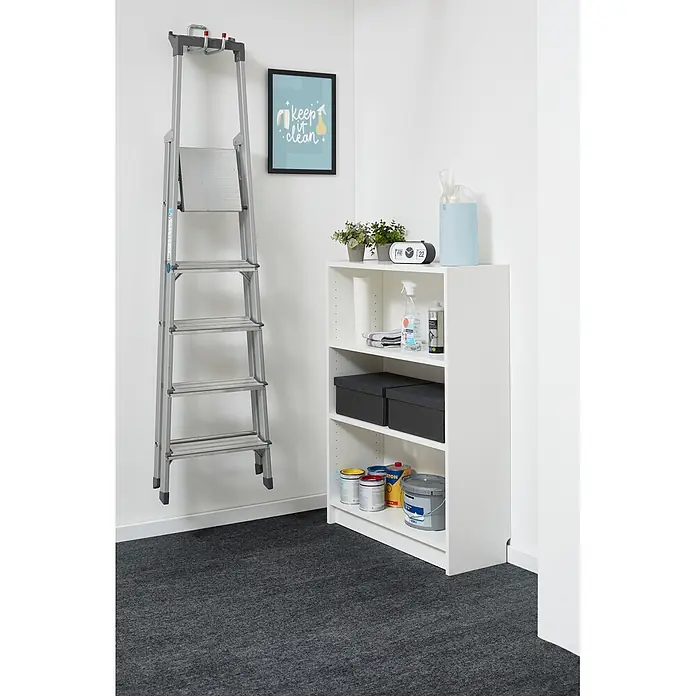 Teppichfliese Filzfliese - 40 x 40 cm, Anthrazit, Selbstklebend, 100 % Polypropylen - Eine silberne Stehleiter hängt an der Wand neben einem weißen Regal mit Reinigungsutensilien und Farbeimern in einer Raumecke.