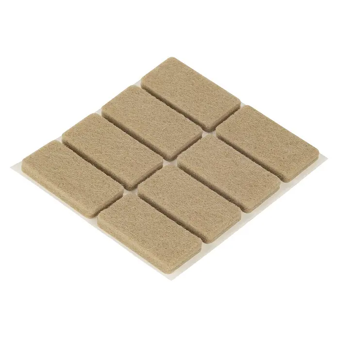 Fix-o-moll Filzgleiter - B x H: 40 x 20 mm, Kleben, 8 Stk., Weiß - Zehn hellbraune rechteckige Filz-Möbelgleiter auf einer Platte. Zum Bodenschutz und zur Geräuschminderung.