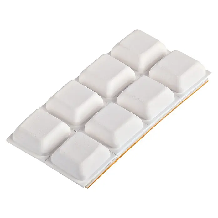 Fix-o-moll Gummiauflage - B x L: 15 x 15 mm, 8 Stk. - Weißer Reinigungsblock mit acht erhöhten quadratischen Pads, eine orangefarbene abrasive Schicht am Rand sichtbar.