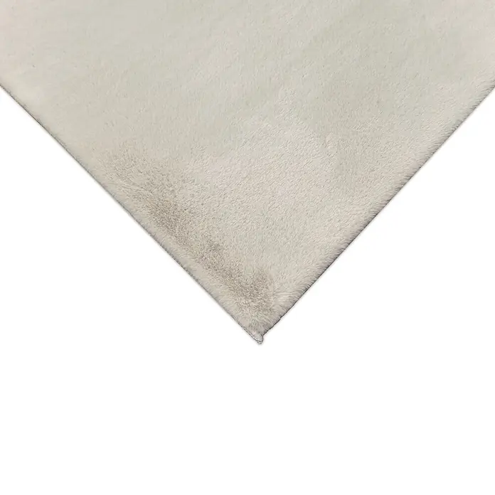 Alfombra de pelo corto Bunny - Beige, 110 x 60 cm, 100% poliéster - Primer plano de una manta o alfombra suave y esponjosa de color crema con textura visible.