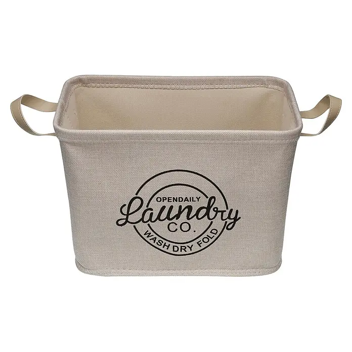 Versa Cesta de tela Laundry - L x An x Al: 26 x 38 x 26 cm, Crema, Poliéster - Cesto de ropa beige de tela con asas y el logo "Laundry Co.".