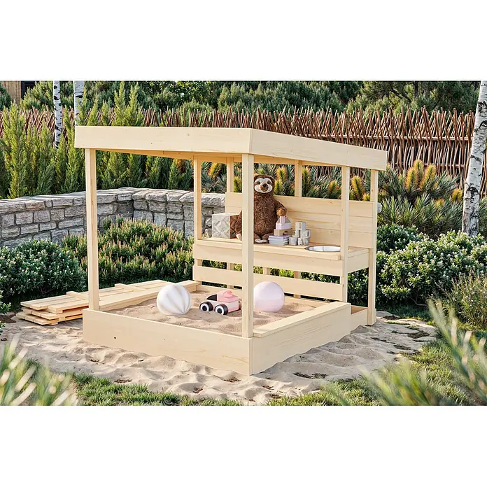 Karibu Sandkasten Max - 135,5 x 11,5 x 122,5 cm, Holz, Holzfarben - Helle Holzsandkiste mit Vordach, gefüllt mit Sand und Spielzeug.