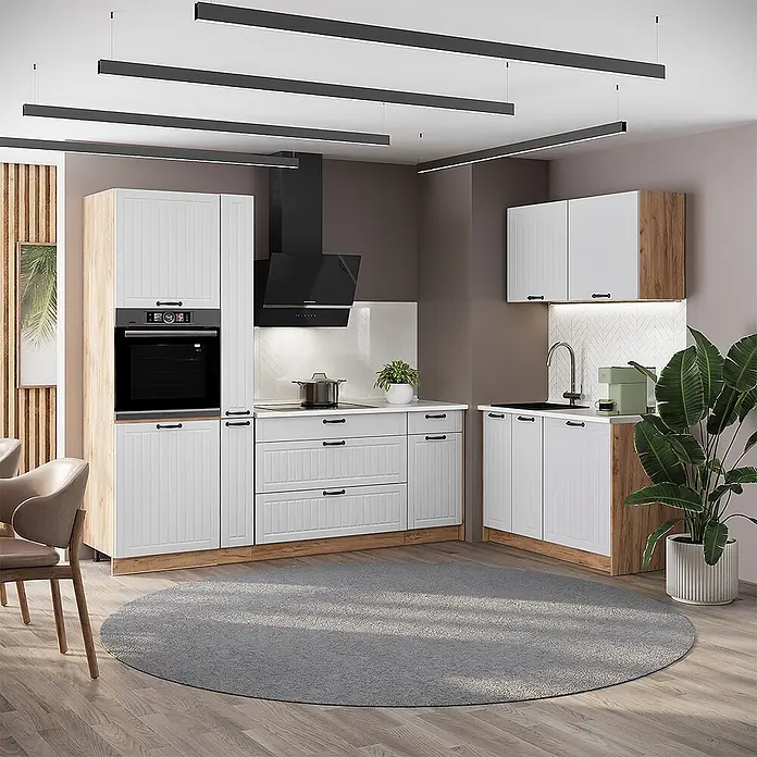 Vicco Eckküche - B x T: 220 x 60 cm, Weiß Landhaus, Ohne Elektrogeräte - Moderne Küche mit weißen geriffelten Schränken, hellen Holzakzenten und schwarzen Griffen, mit Backofen, Kochfeld und Spüle.