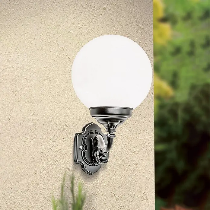 Orion Leuchten Außenwandleuchte Reika - 60 W, Schwarz, Opal, IP43 - Schwarze, verzierte Außenwandleuchte mit kugelförmigem weißem Diffusor, an einer strukturierten Wand montiert.