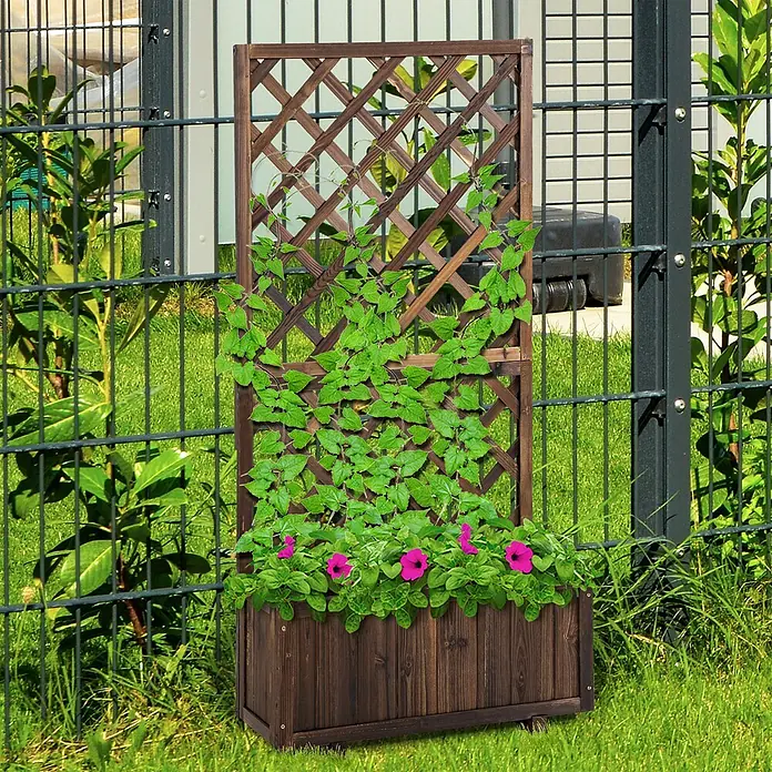 SONNENH Hochbeet schmal, mit Rankgitter - Holz, braun - Dunkelbrauner Pflanzkasten aus Holz mit integriertem Spalier, gefüllt mit grünen Pflanzen und rosa Blumen, auf Gras stehend.