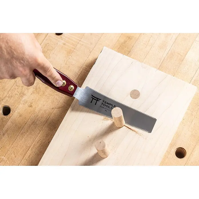 Temple Tool Japansäge Flush Cut - Blattlänge: 150 mm - Hand benutzt eine Temple Tools Japansäge mit rotem Griff, um einen Holzdübel zu kürzen.