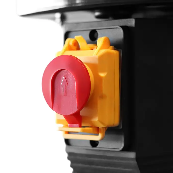 STAHLWERK Bohrmaschine BD-550 ST Säulenbohrmaschine 550W Leistung - 550 W - Roter Not-Aus-Taster mit Aufwärtspfeil auf gelbem Schaltergehäuse, an schwarzem Gerät montiert.