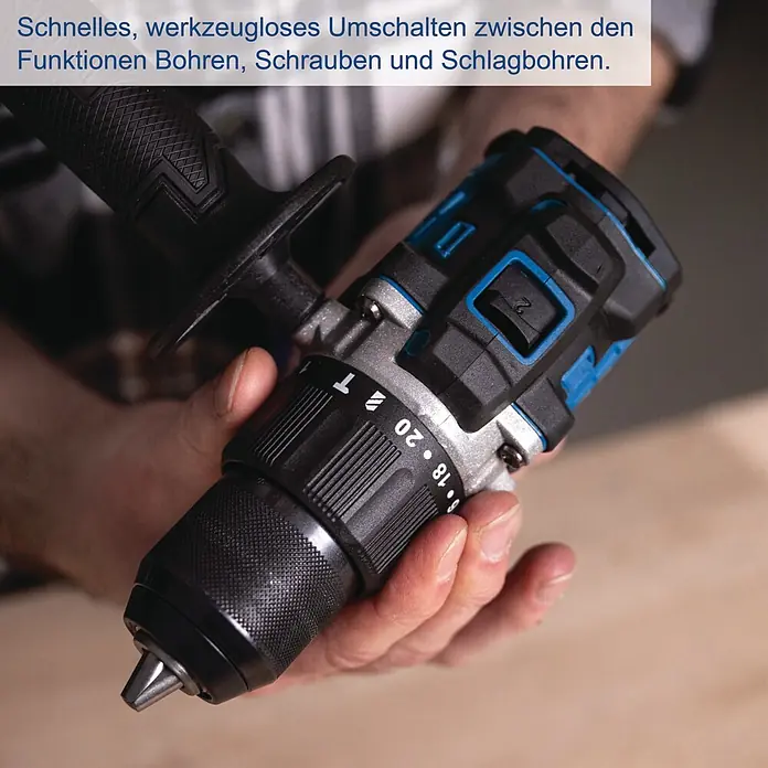Scheppach IXES 20V Akku-Schlagbohrschrauber BC-CD70SC-X - 20 V, Ohne Akku, 70 Nm - Eine Person hält einen schwarzen und blauen Akku-Bohrschrauber. Der Modus-Wahlring zeigt Einstellungen für Bohren, Schrauben und Schlagbohren.