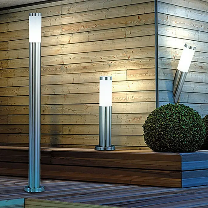 Globo Boston Außenwandleuchte - 8,5 W, 7,6 x 7,6 x 40 cm, Edelstahl, IP44 - Edelstahl-Außenleuchten beleuchten eine Holzterrasse mit stilvollem Design. Die Lampen sorgen für eine moderne Atmosphäre im Garten.
