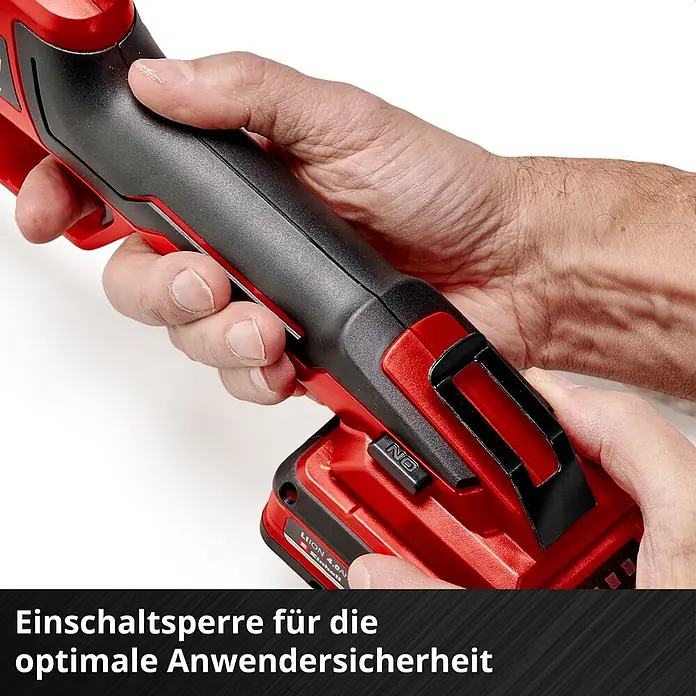 Einhell PXC 18V Einhand-Akku-Kettensäge GE-PS 18/15 + GE-LS 18 - 18 V, 2,5 Ah, Li-Ionen, 1 Akku, Schwertlänge: 15,8 cm - Hände halten ein rot-schwarzes Elektrowerkzeug, der Sicherheitsschalter für optimalen Schutz ist sichtbar.