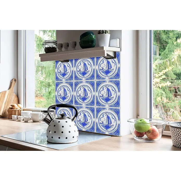 Tulup Wandfliese - Glänzend - Blau-weißer Fliesenspiegel mit Segelbootmotiv, in einer Küche unter einem Regal und neben einem Fenster installiert.