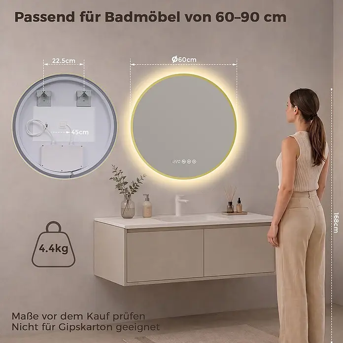 S'AFIELINA Lichtspiegel Luna Select - 60 x 60 cm, Leuchtmittel - Runder LED-Spiegel mit goldenem Rahmen und Digitalanzeige, beleuchtet über einem Waschtisch montiert, mit einer Frau daneben zur Größenreferenz.