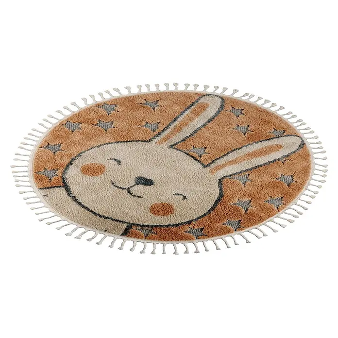 Kayoom Kinderteppich Modena 415 - Beige, Durchmesser: 133 cm, 100 % Polypropylen - Runder Kinderteppich mit cremefarbenem und braunem Hasengesicht, umgeben von braunen Sternen auf beigem Grund, mit Quasten.