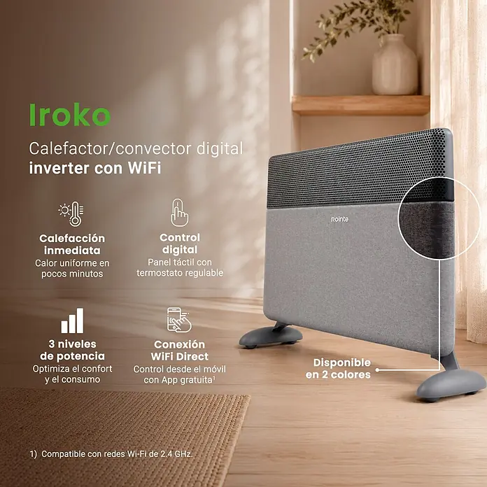 Rointe Convector Iroko - 2.000 W, 12 x 80 x 42 cm, Antracita - Un calefactor inversor digital gris moderno con cuerpo texturizado y parte superior perforada, de pie sobre un suelo de madera.