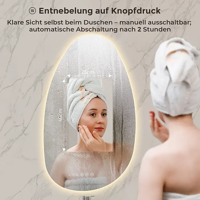 LED Badspiegel 85 x 50 cm, asymmetrisch, 3 Lichtfarben, dimmbar, Bluetooth -  - Ein ovaler LED-Spiegel mit Entnebelungsfunktion zeigt ein klares Spiegelbild einer Frau, während der Rest des Spiegels beschlagen ist. Maße 40x25cm sichtbar.