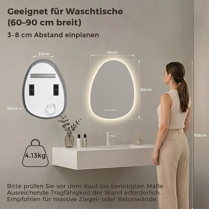 LED Badspiegel 60 x 45 cm, asymmetrisch, 3 Lichtfarben, dimmbar, Bluetooth -  - Organisch geformter LED-Spiegel (45x60cm, 4.13kg) über einem Waschbecken, mit Frau als Größenvergleich.
