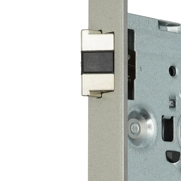 Bever Einsteckschloss mit Flüsterfalle - Buntbartschlüssel, Dornmaß: 55 mm, Links, Stulpbreite: 24 mm, Stulpform: Eckig - Nahaufnahme eines silbernen Metalltürschlossmechanismus mit weißem und schwarzem Riegel.