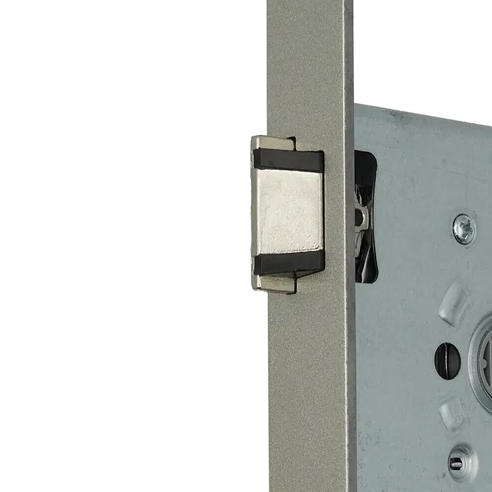 Bever Einsteckschloss mit Flüsterfalle - Zylinderschlüssel, Dornmaß: 55 mm, Links, Stulpbreite: 24 mm, Stulpform: Eckig - Nahaufnahme eines silbernen Metalltürschlossmechanismus, der die Falle und innere Komponenten zeigt.