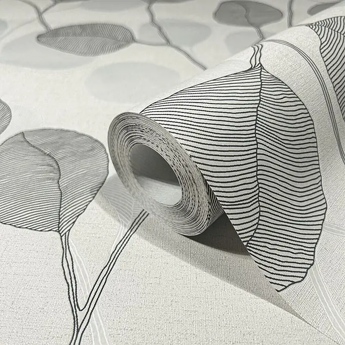 Marburg GZSZ Papel pintado de vinilo - Gris, Floral, 10 x 0,53 m - Rollo de papel pintado claro texturizado con patrón de hojas negras y grises, parcialmente desenrollado.