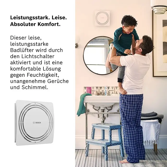 Bosch Wandventilator Fan 1900 W 100 - Weiß, Durchmesser Anschluss: 10 cm, Mit Lichtschalterfunktion - Weißer quadratischer Bosch Badlüfter, an einer Badezimmerwand installiert, wo ein Mann ein Kind hält.