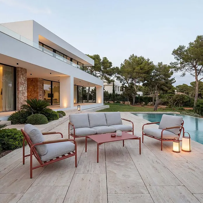 Mendler Alu-Gartengarnitur HWC-O11 3-Sitzer - terrakotta Polster beige -  - Terracottafarbene Outdoor-Lounge-Gruppe mit 3er-Sofa, zwei Sesseln und Kaffeetisch, mit hellgrauen Polstern, auf einer Terrasse.