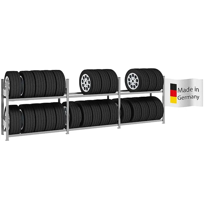 Proregal Reifenregal TIRE PRO - H x B x T: 115 x 390 x 43 cm, Stecken, Verzinkt - Silbernes Metall-Reifenlagerregal, gefüllt mit schwarzen Autoreifen und silbernen Felgen, mit „Made in Germany“-Flagge.