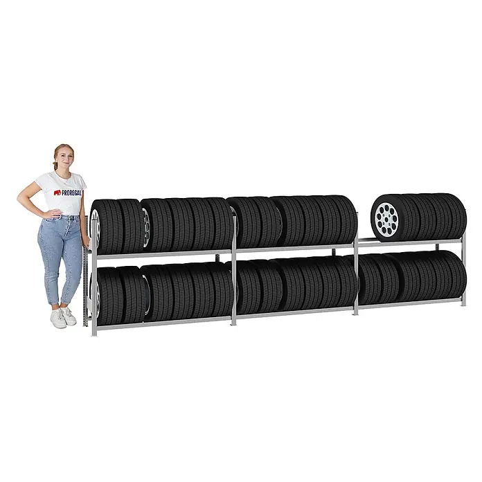 Proregal Reifenregal TIRE PRO - H x B x T: 115 x 450 x 43 cm, Stecken, Verzinkt - Silbernes Reifenregal mit zwei Ebenen, voll mit schwarzen Reifen, neben einer Frau zur Größenreferenz.