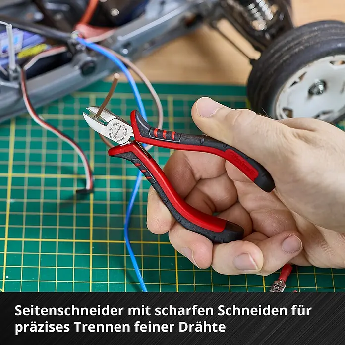 Einhell Werkzeugsatz-Einlage E-Case Feinmechaniker Zangen - 8 -tlg. - Eine Hand benutzt rot-schwarze Seitenschneider mit scharfen Chrom-Vanadium Klingen zum präzisen Schneiden eines feinen Drahtes.