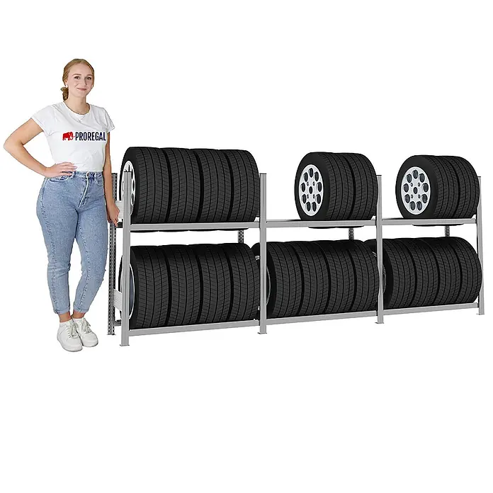 Proregal Reifenregal TIRE PRO - H x B x T: 115 x 300 x 43 cm, Stecken, Verzinkt - Silbernes Metall-Reifenlagerregal, gefüllt mit Autoreifen, mit einer Frau daneben zur Größenreferenz.