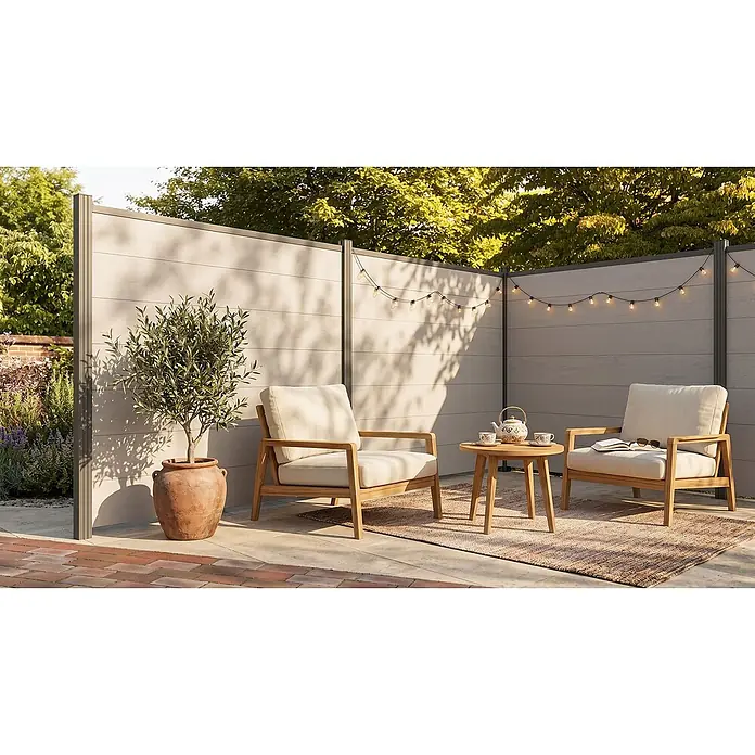 GartenLand Steckzaun-Element WPC Zaun Ameland Ohne Pfosten Ohne Abschlussleiste - B x H: 180 x 180 cm, Sand-Multicolor, Verbundwerkstoff - Heller WPC-Sichtschutz mit dunklen Pfosten in einem Sitzbereich im Freien, ergänzt durch Lichterketten.